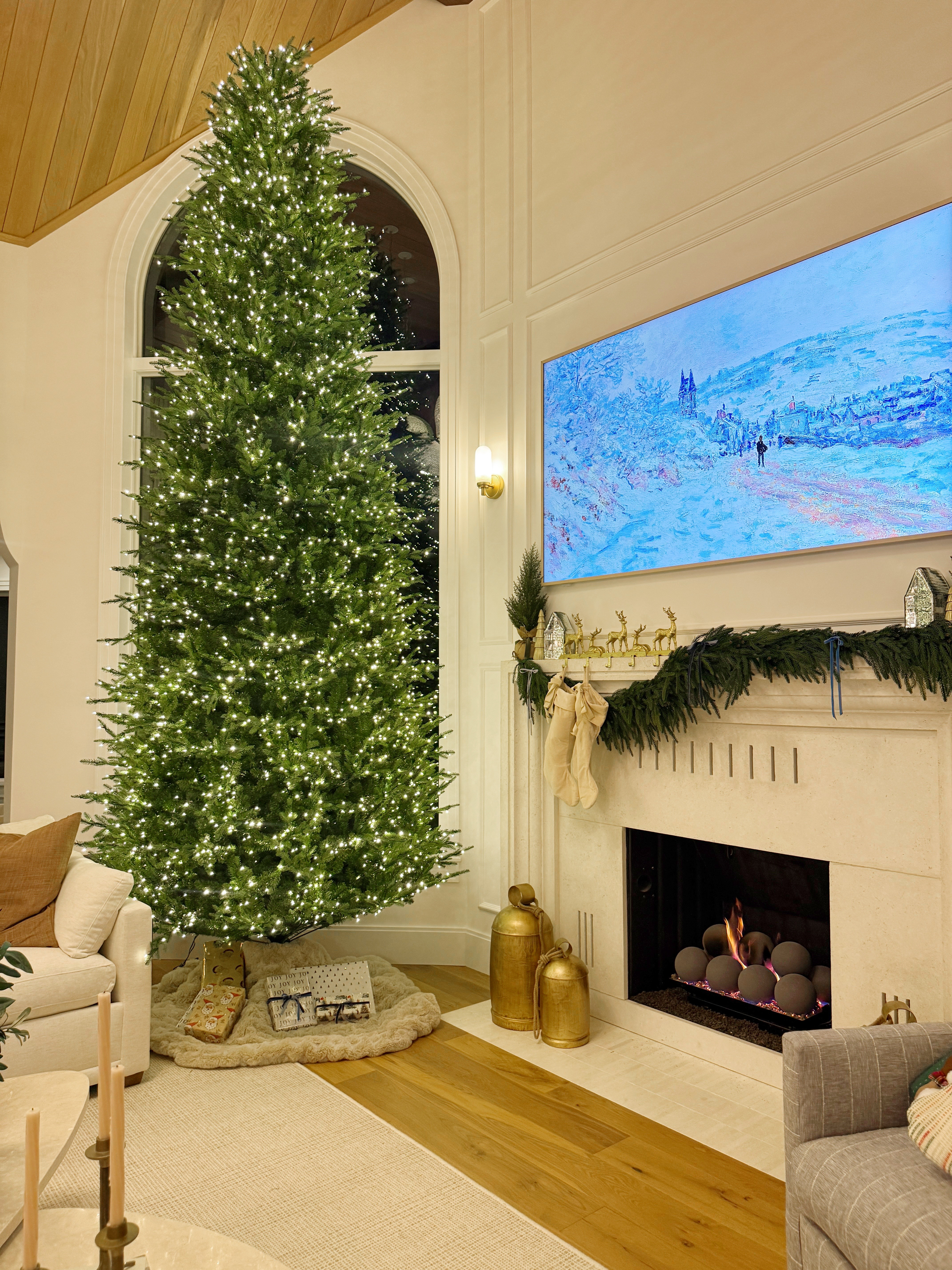 Holiday mantle decor with prelit faux Christmas tree! #garland #bells #mantle #livingroom #stockings 

 #LTKHoliday #LTKSeasonal #LTKHome