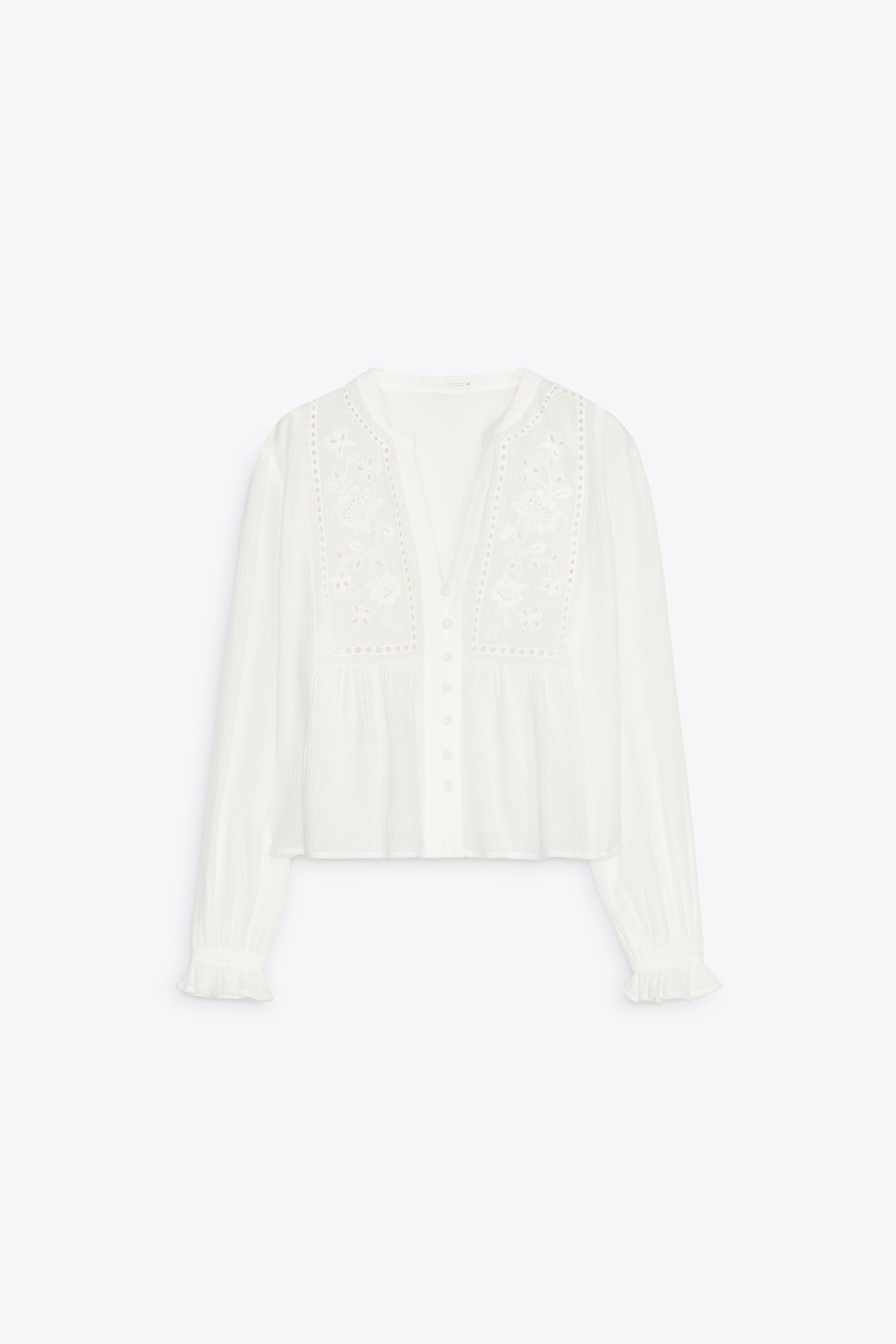 Round neck blouse with V-neckline and long sleeves with ruffled cuffs. Tonal embroidered eyelet d... | Zara US