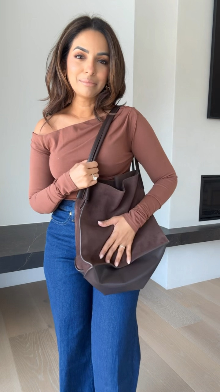 This asymmetrical top from J.Crew is the cutest! Would pair with faux leather pants for a date night look. This suede bag is also perfect for fall. Wearing size XS in the top and 25 Petite in the jeans!

#LTKSeasonal #LTKFindsUnder100 #LTKStyleTip