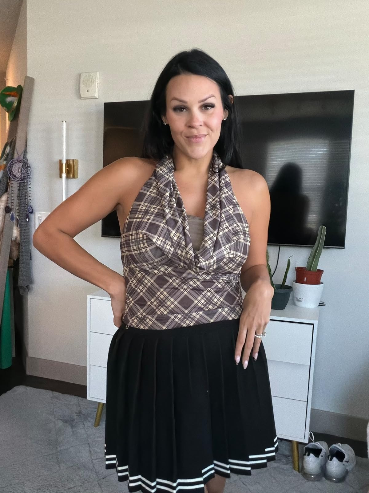 Stay chic in this brown plaid halter top paired with a classic black pleated mini skirt. A perfect mix of pattern and texture for a preppy yet edgy vibe! #PlaidStyle #PleatedSkirt #PreppyChic 

 #LTKdayinmylife #LTKootd #LTKSaleAlert