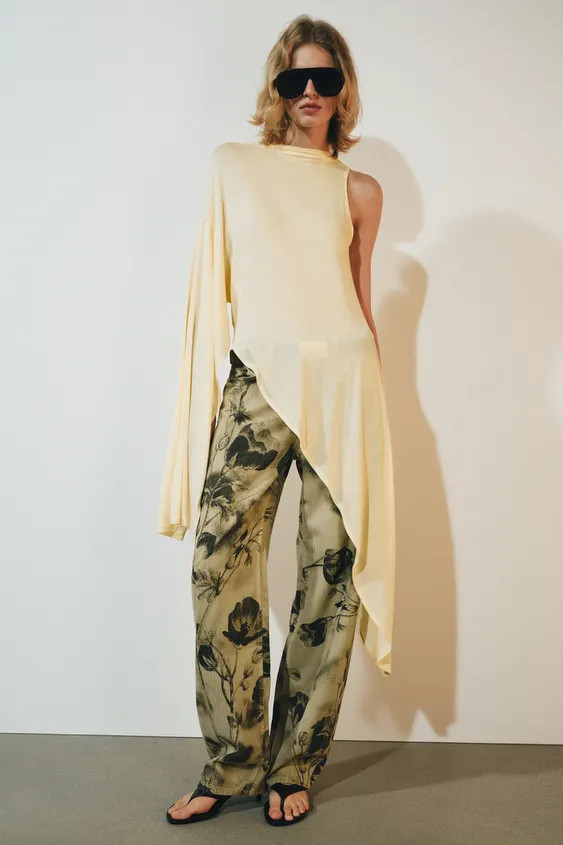 Top made of a lyocell blend. Round neck with asymmetric sleeves. Straight hem. | Zara UK