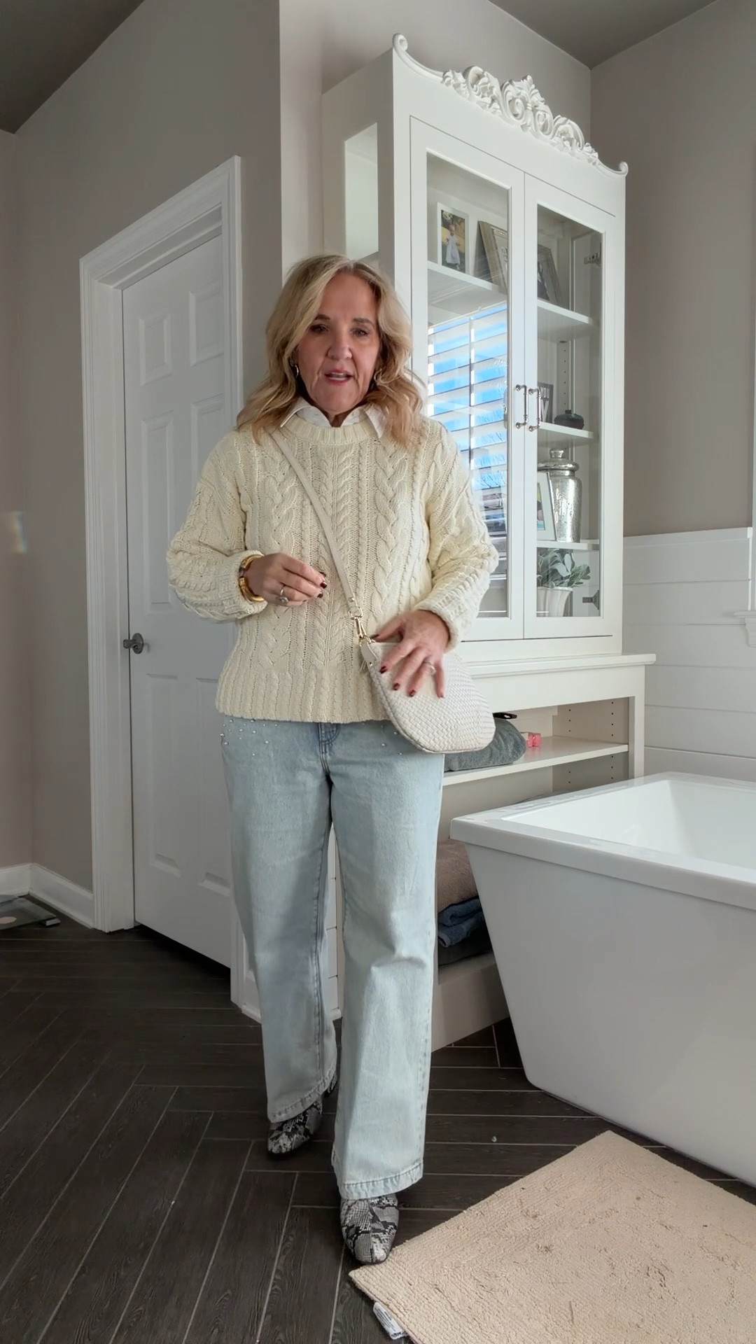 Sweater restocked lovely cotton cable ecru winter white wearing a medium 
Pearl embellished jeans 29 petite 
Blouse size medium 
Bone winter white purse this is the small version 
Eby bra 30% off right now 

#LTKOver40 #LTKFindsUnder100 #LTKPetite