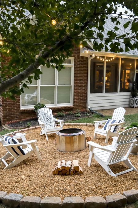 Our family really enjoys our fire pit area with a low smoke Solo stove and comfortable Adirondack chairs. The string lights from the house to the tree add to the ambiance .

#LTKHome