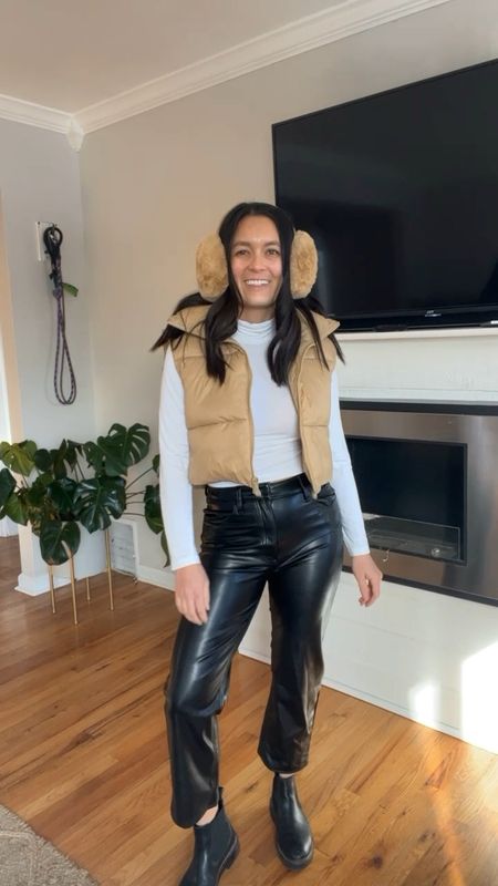 Winter outfit idea. Vegan leather pants Abercrombie for petite girls. Amazon puffer vest. White turtle neck amazon. Brown and tan fuzzy earmuffs from amazon. Ski trip. Mountain town outfit. Winter vacation. 

#LTKunder100 #LTKSeasonal #LTKtravel