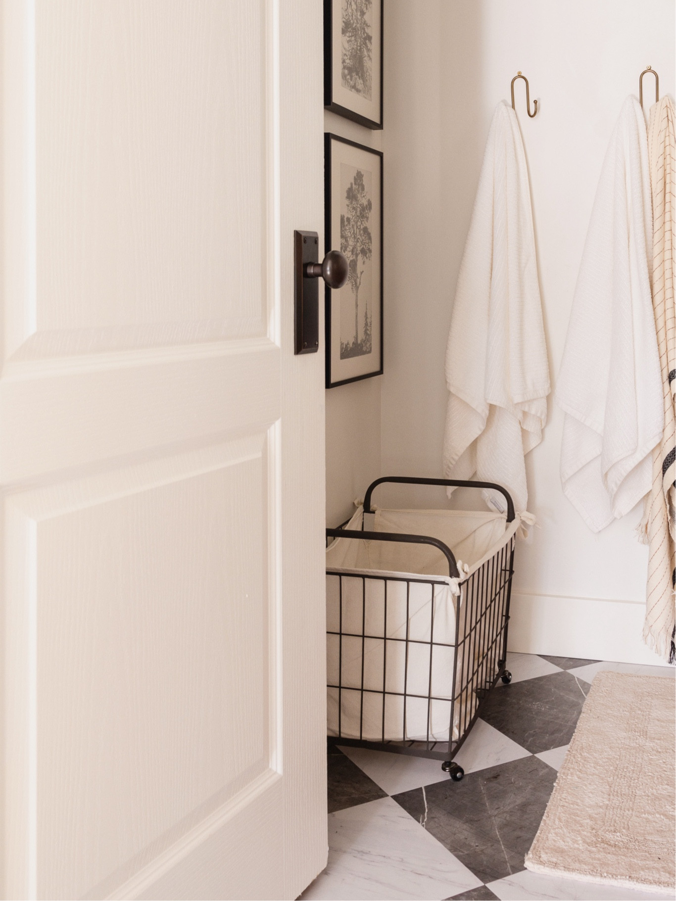 Guest bathroom makeover: Chris Loves Julia checkered floor tiles, vintage tree framed art, beautiful door hardware

#LTKhome