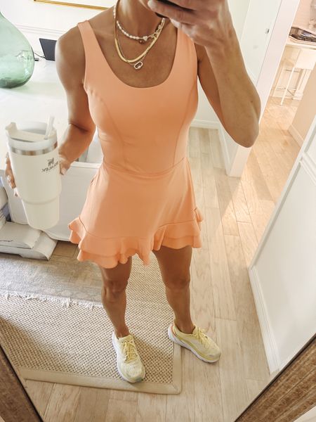 Tennis/Target Tuesday. Found the cutest athletic dress from target. Hem has ruffle detail. Love the back. Could do a matching sports bra under or another color that coordinates to change it up. Built in shorts. Shelf bra. Comes in white and black also. I’ve been gravitating toward all hues of orange 🍊 lately  I’m wearing the size small. Runs short not necessarily “big”. Wear for tennis, pickleball, running errands, on your walk, to a workout  

#LTKfit #LTKunder50 #LTKFind