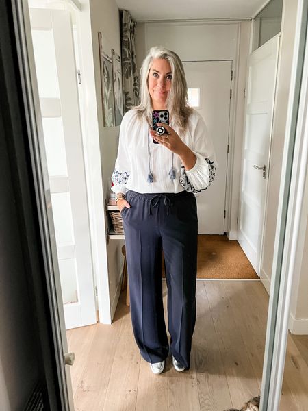 Outfits of the week. Navy blue drawstring crepe trousers paired with a white embroidered blouse with puff sleeves and silver loafers. Both the blouse and loafers are old but I have linked similar items  