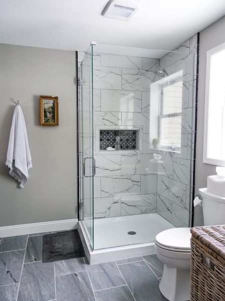 Our tile shower turned out incredible with a marble look a like porcelain tile and honed marble niche mosaic. The floor is porcelain tile as well  

#LTKMostLoved #LTKhome