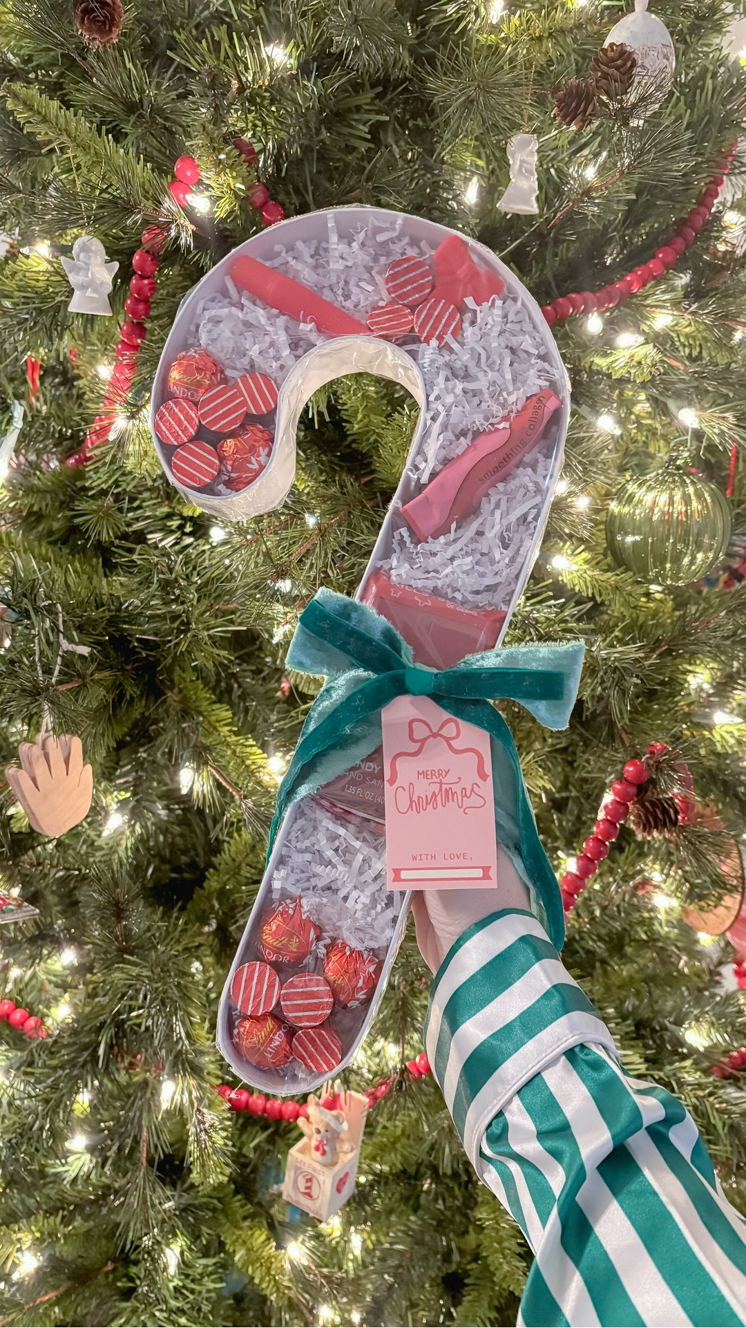 🎁 Gift Idea Series - Part IV 🎁
This candy cane container from Hobby Lobby filled with red “stripe” goodies is such a fun way to gift some of your favorite things! 
Fill a candy cane shaped box with white crinkle paper and then only gift red items to create a candy cane look! ❤️🤍 Perfect for a girls night, Favorite Things party, White Elephant, or even Secret Santa!

#LTKGiftGuide #LTKHoliday #LTKFindsUnder50