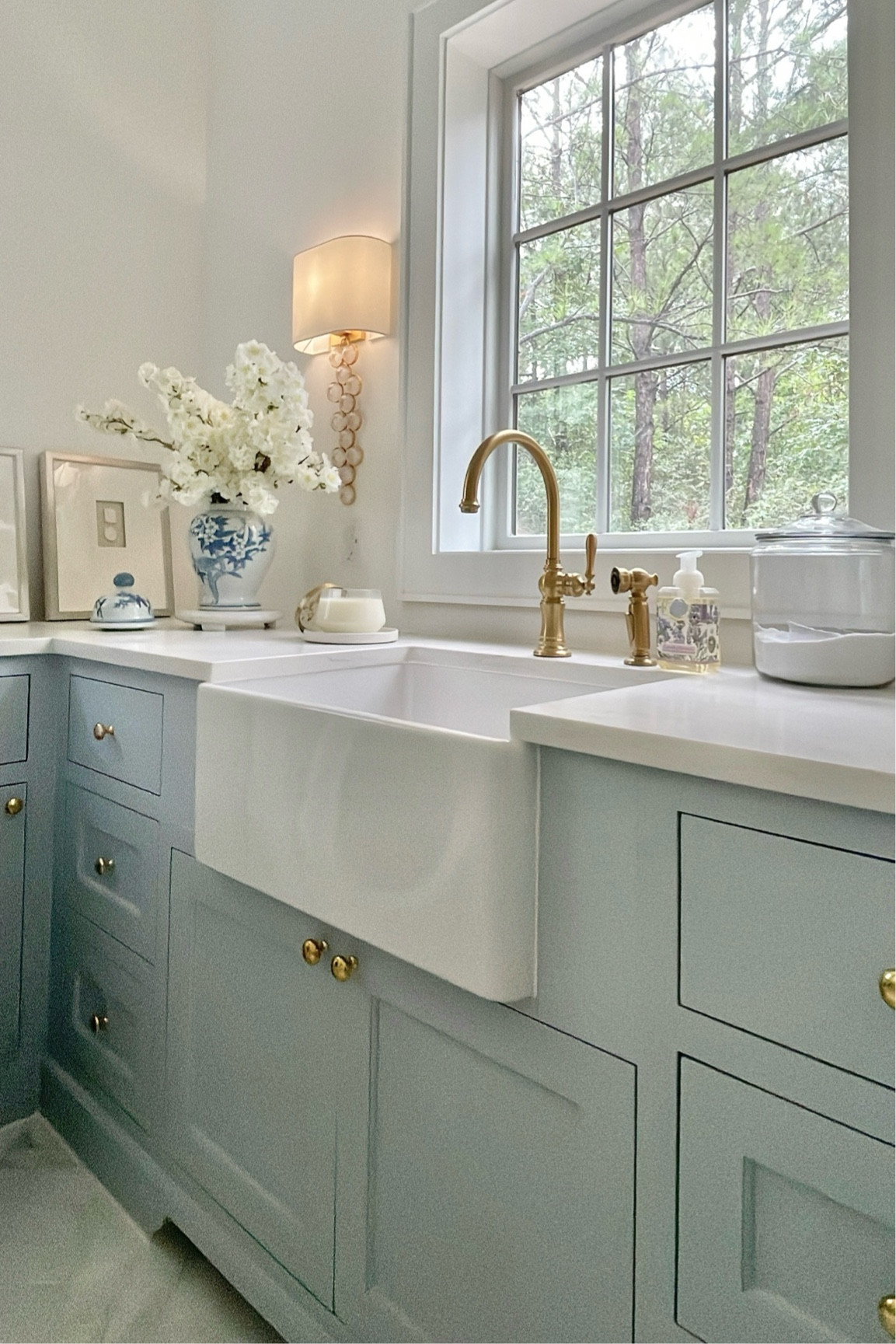 Sneak peek of our new utility room! 
Brass faucet, brass cabinet hardware, knobs, pulls, blue and white ginger jar, canisters, faux stems, light sconces included. Our chandelier (not pictured) is linked as well

#LTKhome