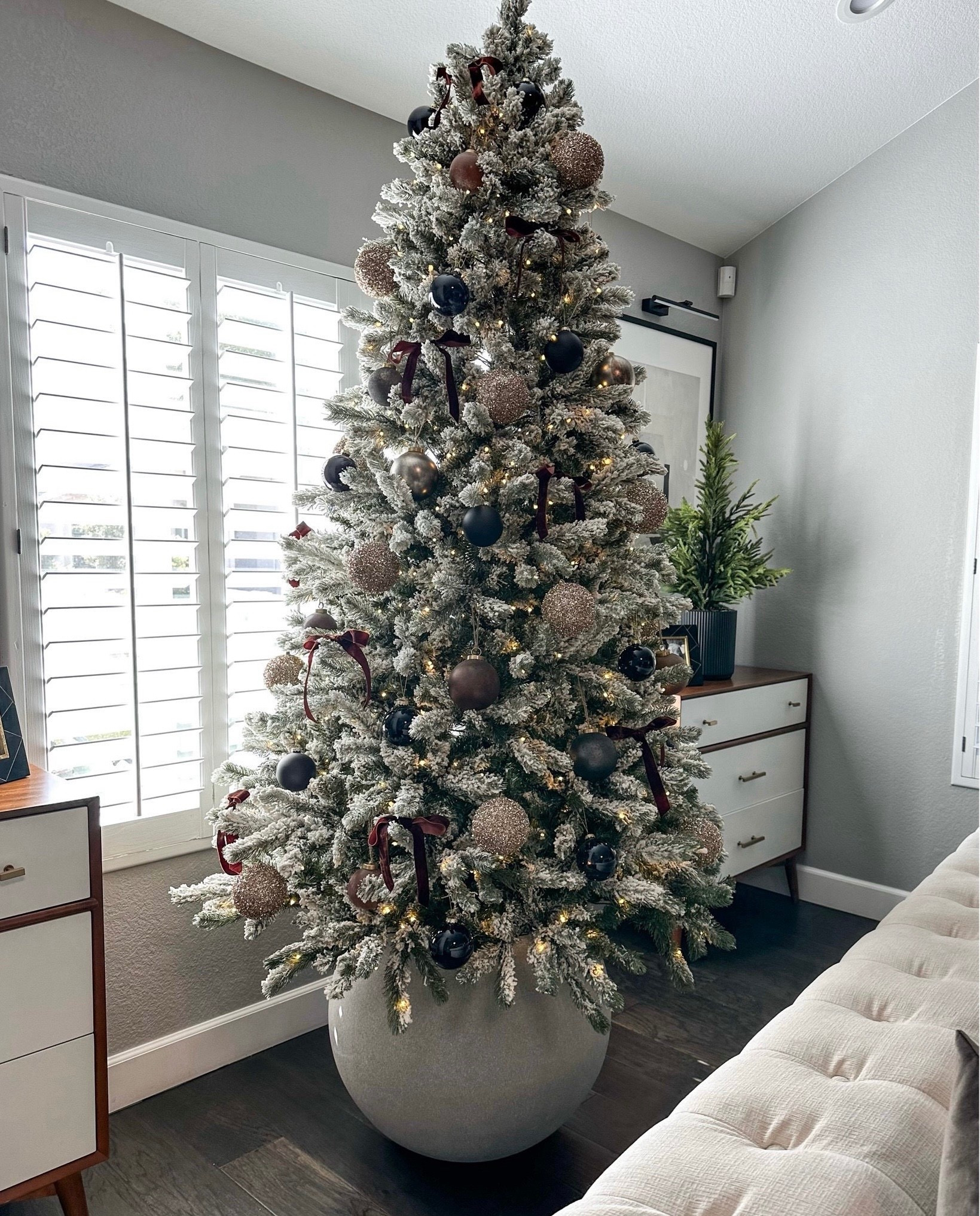 Save $300 on my Christmas tree Flocked tree with round planter base 
Browns, blacks and rust ornaments I’m loving again this year…the crate and barrel ones are my absolute favorite!
I always have 7 trees out but I will change them up, switch up which trees get what ornaments, or rotate the trees out each year depending on my mood..I’ve never had a tree in this spot and love that the planter raises it higher than the couches to see it better, and it’s different and modern 
Modern organic, neutral Christmas decor 
#ltkseasonal


#LTKHoliday #LTKHome #LTKStyleTip