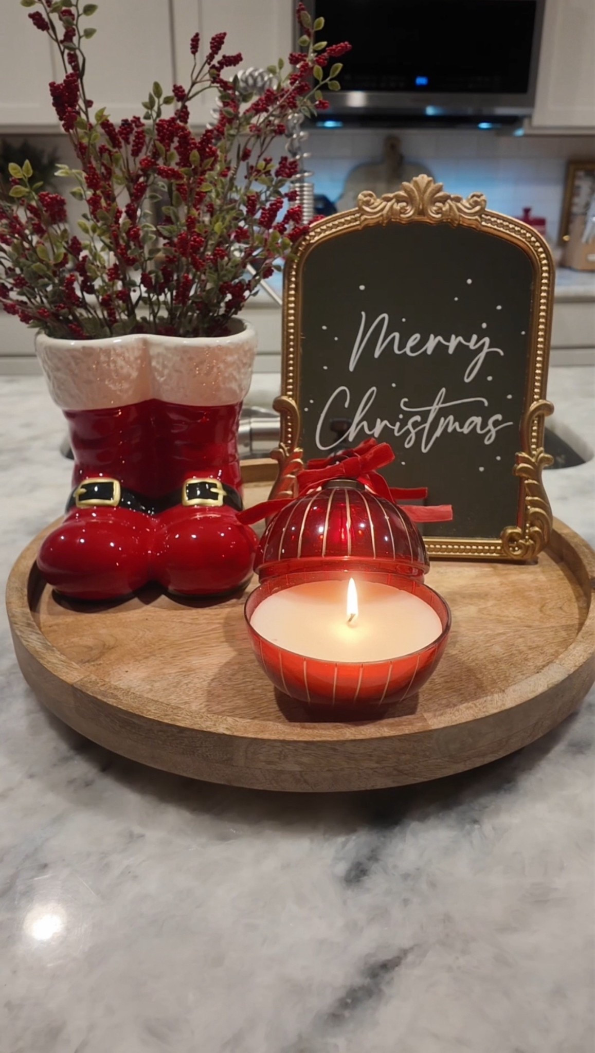Christmas centerpiece idea 🎄🤶 ✨ A classic Christmas centerpiece for my kitchen island 🎅🏻 simple, cute, and festive! 🎄❤️ I love mixing red accents, greenery, and warm candlelight for that cozy holiday look.
In this post: Santa boot vase with berry stems, ornament candle, and a mini gold-frame sign 🎀✨ #christmascenterpiece
#christmashomedecor #christmasdecor #christmaskitchen #christmas2025 

#LTKCyberWeek #LTKHome #LTKHoliday