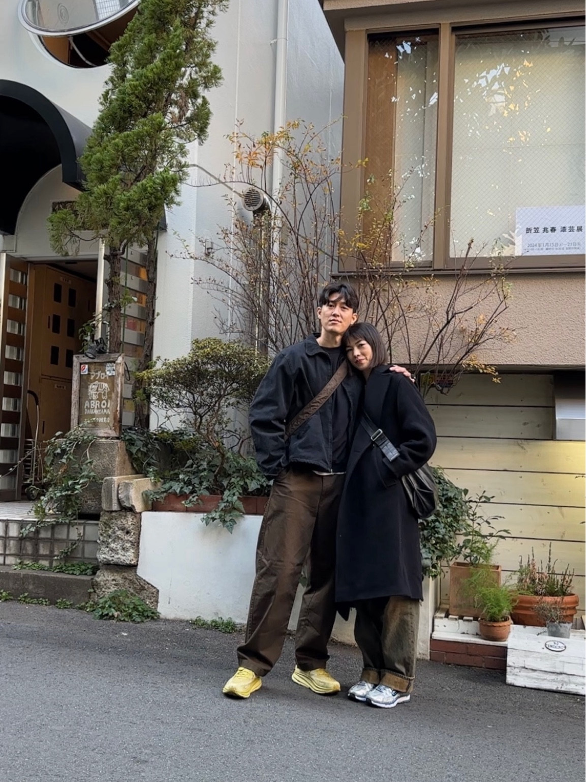 Anna: 
Coat: cos, jeans: eytys, shoes: Nike p6000, bag: Japanese brand (unlabeled)

Kevin:
Jacket: no maintenance, pants: Uniqlo, shoes: hoka