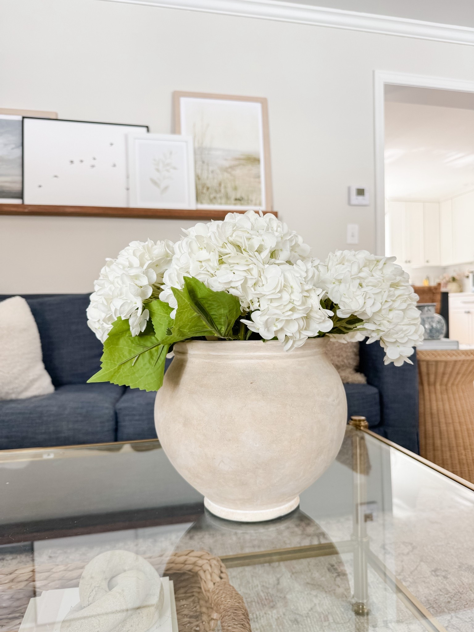 Coastal living room styled with neutral throw pillows, textured ivory rug, faux florals, and layered sofas for a relaxed high end coastal look.

coastal living room decor,  neutral sofa styling, coffee table florals, light coastal interiors, sherricalnanhome

#LTKHome
