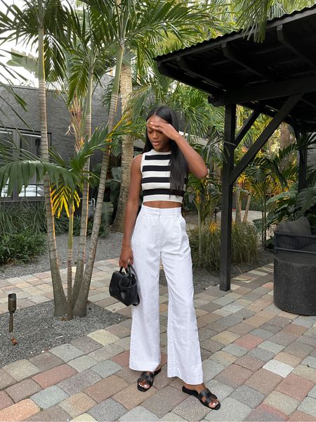 Black and white striped top, white linen pants, Abercrombie pants, Black Oran sandals, Palm Beach outfit, resort style, spring outfit — use code: AFLTK to get $$ off of pants during the LTK Sale!

#LTKSeasonal #LTKSale #LTKunder100
