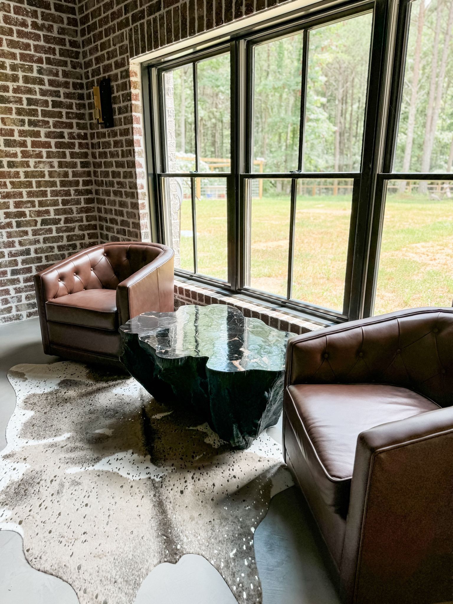 Bar lounge area. Complete with whiskey swivel chairs, drink table and cowhide.

#LTKHome