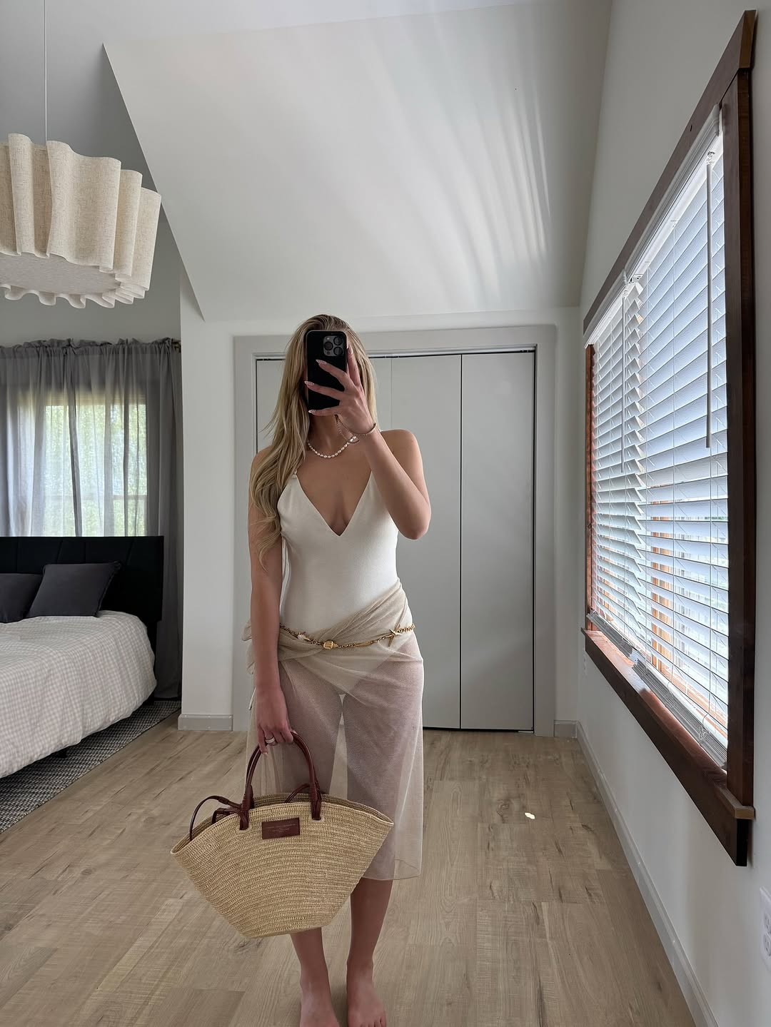 Lakeside luxe. A white V-neck bodysuit paired with a sheer champagne sarong, gold waist chain, and a large straw tote for effortless vacation vibes. #LakesideStyle #BeachCoverUp #LTKtravel 

 #LTKgrwm #LTKootd #LTKSaleAlert