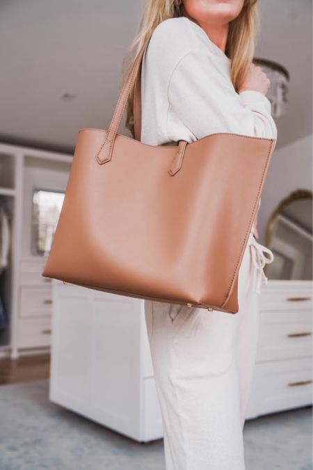 Tote bags are great for travel, work, and busy moms. This carry-all is a workhorse and again SUPER lightweight. Especially considering the size. It’s also made of Italian leather and since it has no hardware at all, and is a simple design, it’s as timeless as it is chic.

It has a center zipper divider which is large enough for your device or laptop. Sometimes larger totes like this can make it difficult to find smaller items like keys, glasses, and lip-gloss, but this one has 3 slip pockets to help keep you organized. I have it in the Cappuccino color, but it also comes in 5 other shades. This bag is also an amazing price point for a large tote at $150. Say hello to your summer carry-all!

~Erin xo 

#LTKItBag #LTKWorkwear #LTKSeasonal