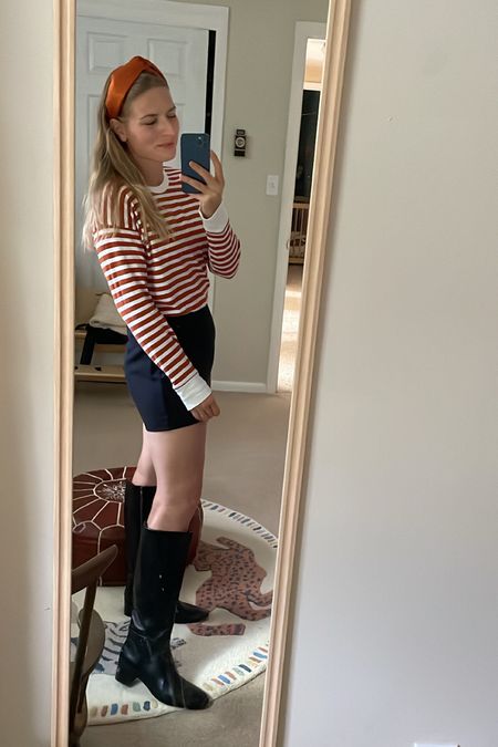 Casual fall girlie outfit of the day 🍁 I bought these boots on sale last year in regular calf and they were just a tad too small. These extended calf are 👌 for athletic calves. I already know I’m going to wear them so much this fall and winter.

Skort, orange top, Halloween, fall ootd, prep, tall boots, leather boots 

#LTKSeasonal #LTKshoecrush