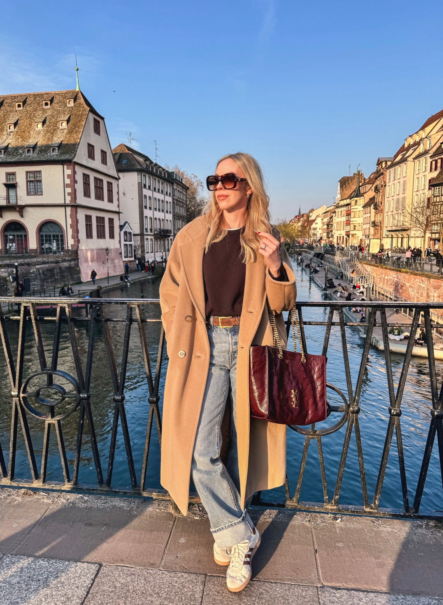 Spring outfit 2026, travel look, spring casual, camel coat, Levi’s 90’s baggy jeans, brown suede YSL belt, burgundy YSL tote bag

#LTKOver40 #LTKSeasonal #LTKTravel
