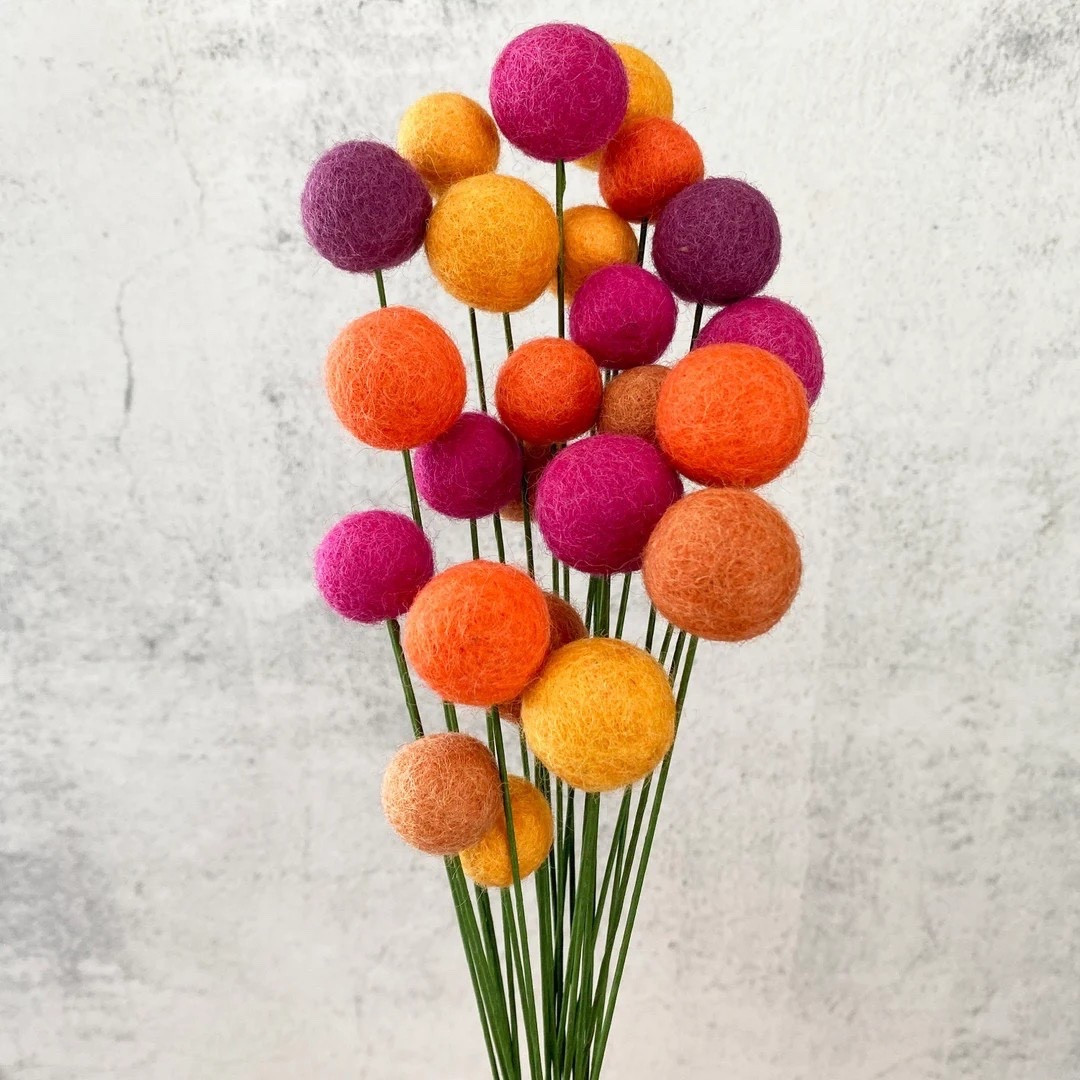 Add a playful pop of color to your decor with these felted wool flower ball bouquets by OakwindAura. Made from 100% wool felt, these whimsical forever flowers are perfect for styling in a vase, grouping in tiny vessels, or mixing into an existing centerpiece for a fun, textured look. Each stem features varying ball sizes for visual interest, with flexible cloth-covered floral wire that’s easy to bend or trim for custom arrangements. Available in bundles of 8, 15, or 30 stems, they’re a charming, season-proof accent you’ll enjoy year after year.

#LTKhome #FeltFlowers #ForeverFlowers #TabletopDecor #HomeStyling #CraftSupplies #EtsyFinds #ColorfulDecor #OakwindAura

#LTKHome #LTKHoliday #LTKSeasonal