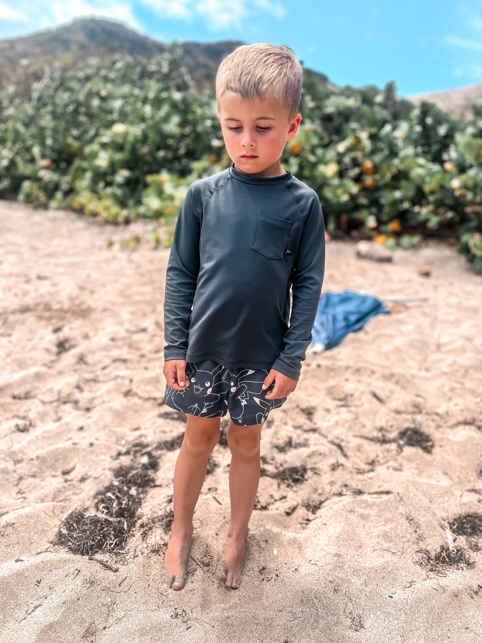 Boys dark grey long sleeve rash guard
Boys black and white swim trunks 