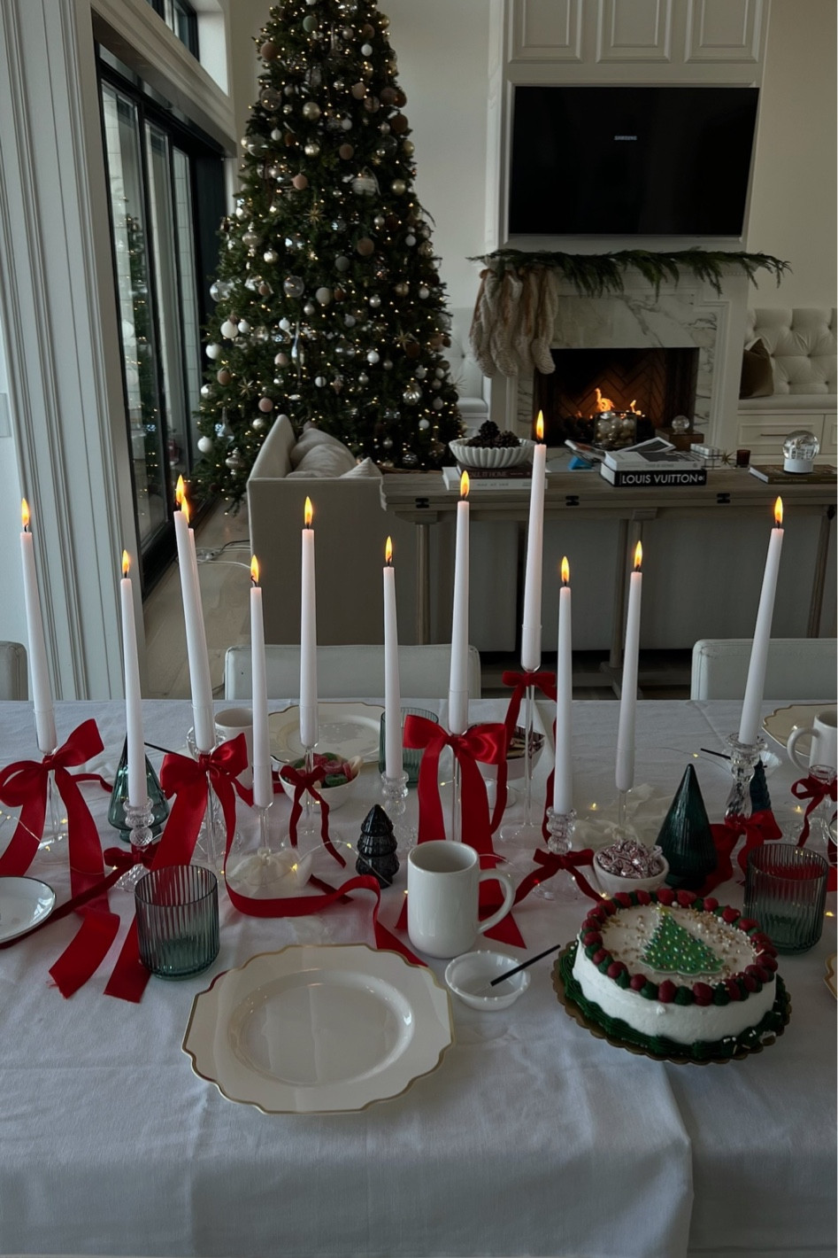 Festive holiday tablescape for a holiday party 🎄✨ I just got these glass candlestick holders - I mixed some more modern candleholders with vintage looking candleholders and then tied ribbon bows around them. I love how it turned out! 

#LTKHoliday #LTKparties #LTKSeasonal