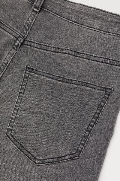 Jeans in washed superstretch denim with a high waist. Zip fly with button, mock front pockets, an... | H&M (US + CA)