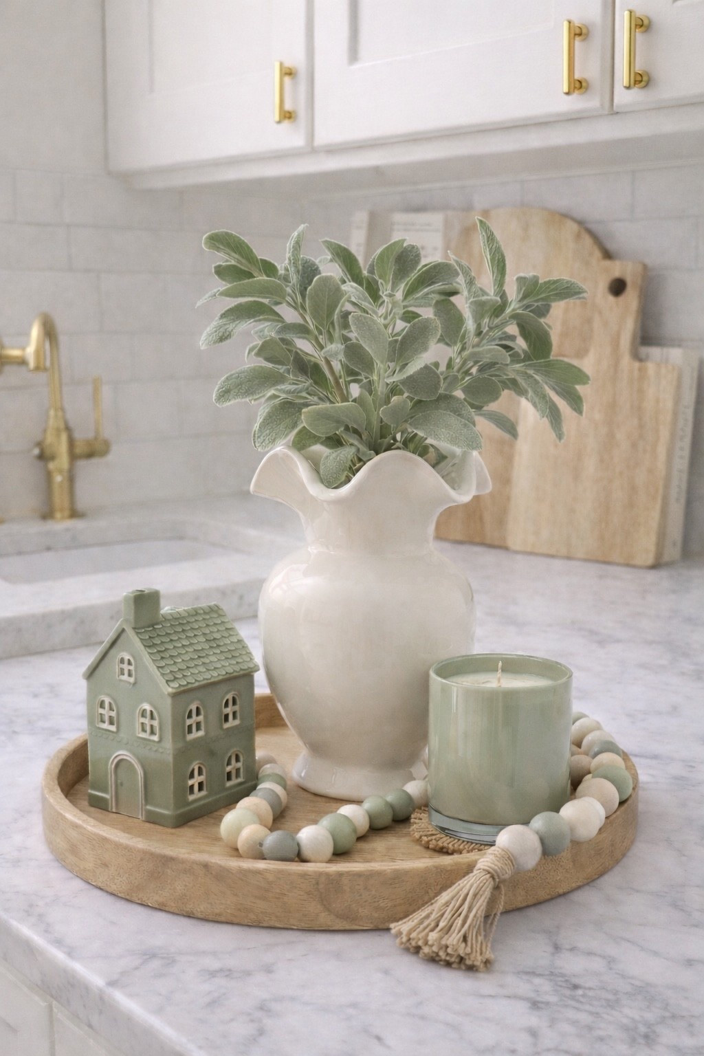 Cozy sage green kitchen counter styling 🌿
A simple tray moment with soft green accents, natural wood textures, and fresh greenery to make the kitchen feel calm and inviting.

Shop similar pieces to recreate this cozy kitchen tray look.

#LTKHome #LTKSeasonal #LTKSpringSale