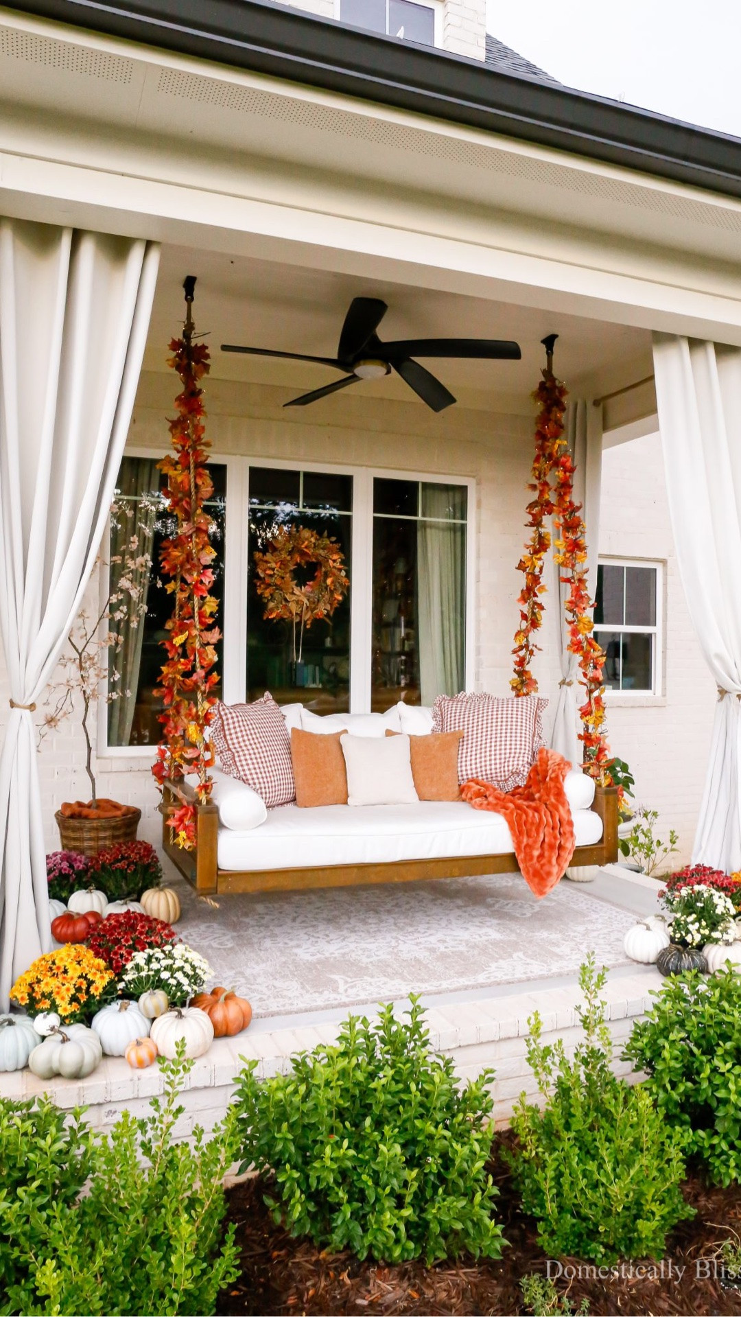 A little Fall Front Porch tour of our bed swing decorated with twinkle lights, fall garlands, lots of colorful mums, cozy pillows & blankets, and faux pumpkins.

#FallDecor

#LTKHome #LTKSeasonal