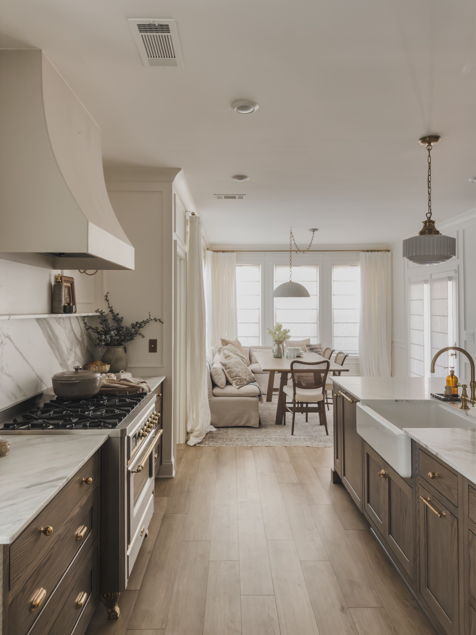 Open concept kitchen views leading into my breakfast nook! I love classic wood tones that lead into a bright and airy space. The cozy corner gives such a collected and timeless feel that my entire family loves to gather around. 

Home finds, neutral home inspo, collected style, timeless home inspo, rich wood tones, creamy whites, furniture favorites, summer style, early fall transition, statement lighting, pendant light, milk glass, brass details, unlacquered brass, marble countertop, breakfast nook, banquette, wooden dining chair, linen curtain, vintage style area rug, cozy throw pillow, linen shade, Two Pages, Visual Comfort, Wayfair, Four Hands, Arhaus, Crate and Barrel, Loloi, Amber Lewis, Rejuvenation, shop the look!

#LTKSeasonal #LTKHome