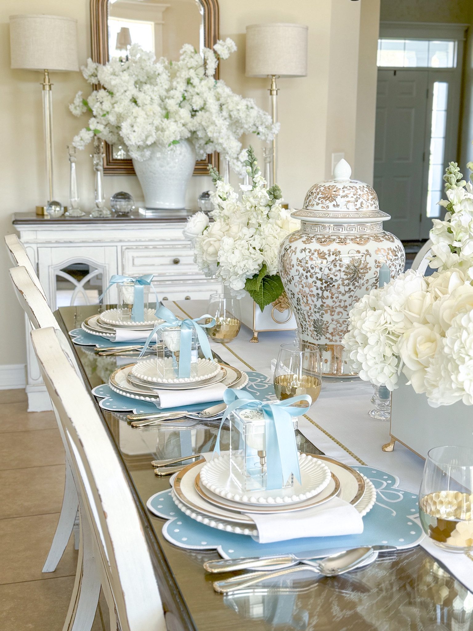 Shop my “Blue-tiful You” Mother’s Day Tablescape!

Acrylic rose box, infinite rose, Mother’s Day gift ideas, Mother’s Day table, gold ginger jar, rectangular planter, faux hydrangeas, faux flowers, faux peonies, white flowers, snapdragon stem, white roses, blue placemats, scalloped placemats, white and gold linens, mother of pearl temple jar, crystal candleholders, crystal orb, white cherry blossoms, centerpiece ideas

#LTKparties #LTKSeasonal #LTKGiftGuide