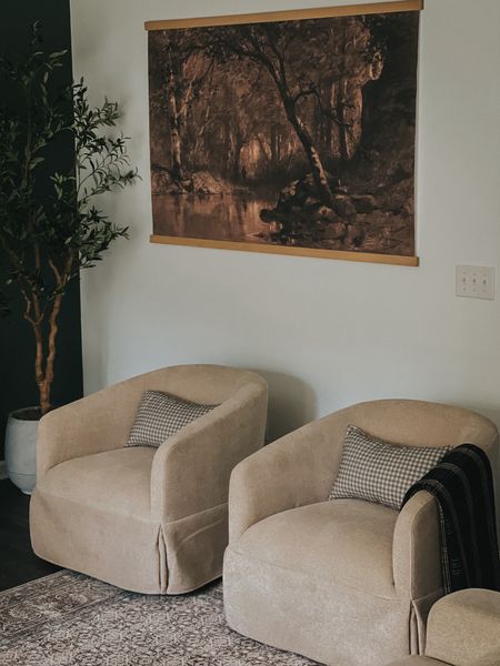 Swivel faux sip covered chairs. Living room seating. Accent chairs. Living rooms. Tapestry canvas. Faux olive tree. Gingham pillows. Plaid blanket. Warm interiors  

#LTKHome #LTKFamily
