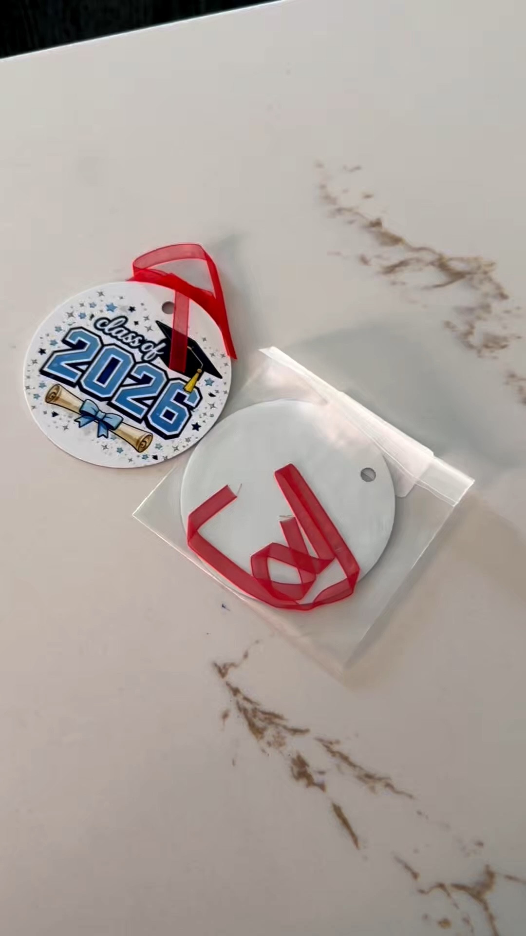 Your favorite graduate deserves more than a card. 🎓 The Class of 2026 ornament is the perfect little keepsake to celebrate all of their hard work and remember this milestone for years to come. Add it to a gift bag, graduation basket, or save it for their first Christmas after graduation. ❤️

#ClassOf2026 #GraduationGift #GraduateGift #Senior2026 #GraduationKeepsake 

#LTKSeasonal #LTKKids #LTKHome