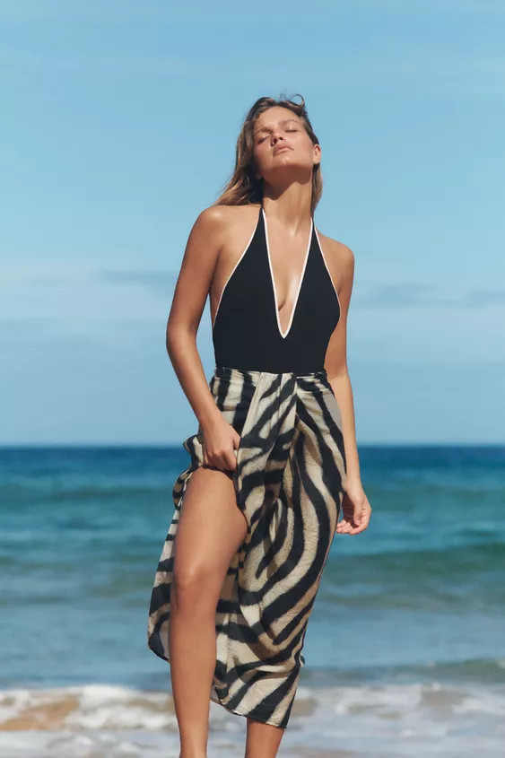 Wrap skirt with a mid waist, front knot, and back zip closure. | Zara US