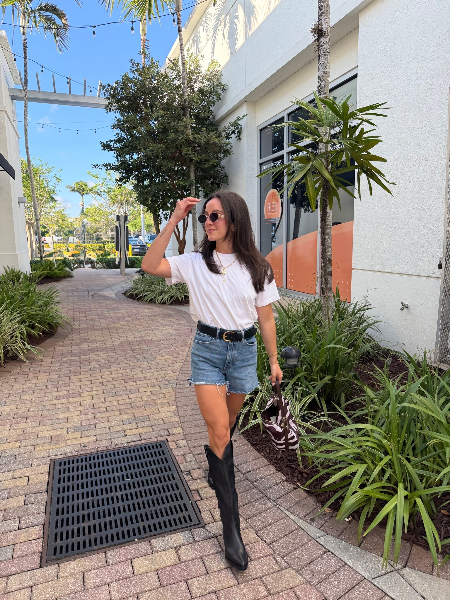 country concert outfit from last night! Would also be cute for festival season. Boots @onequince shorts @abercrombie tee and purse old navy! Obsessed with this zebra handbag, 50% off! Perfect spring outfit for women, spring styles, denim shorts outfit, vacation outfits, date night outfits 

#LTKFestival #LTKootd #LTKSeasonal
