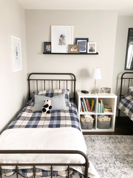 Boys bedroom with budget friendly metal beds, cube shelf for toy and book storage, distressed rug, Star Wars art, and plaid bedding.


#LTKfamily #LTKkids #LTKhome
