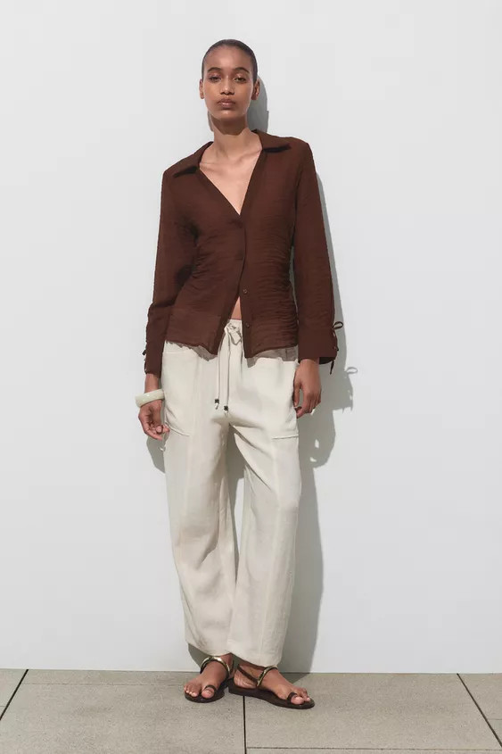 Collared shirt with a V-neck and long sleeves. Fitted waist with gathered sides. Button-up front.... | Zara UK