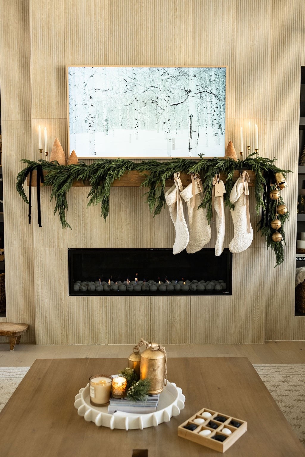 A Christmas view I never get tired of 🤍🎄 Layered lush faux affordable Amazon cedar garland, neutral knit stockings, affordable Amazon gold bells, Target winter artwork, and a cozy coffee table vignette create the warmest holiday atmosphere. Perfect inspiration for neutral Christmas living room decor, modern classic holiday styling, LTK Christmas home finds, winter fireplace decorating, and cozy holiday home ideas. ✨

#LTKHome #LTKSeasonal #LTKHoliday