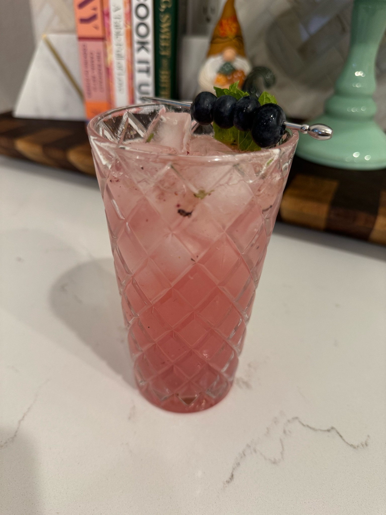 Blueberry Mojito!

Highball glass
Shaker
Strainer

About 10 blueberries 
Fresh mint
2 ounces white rum (more if wanted)
3 ounces club soda
1/2 ounce simple syrup
1/2 ounce lime juice 

Muddle blueberries and some fresh mint in a shaker. 
Add rum, clime juice, simple syrup, and ice. 
Shake well. 
Using strainer, pour over ice in highball glass. 
Pour club soda over top. 
Gently stir  
Add mint sprig and blueberries on a pick. 

#LTKFindsUnder50 #LTKParties #LTKSeasonal