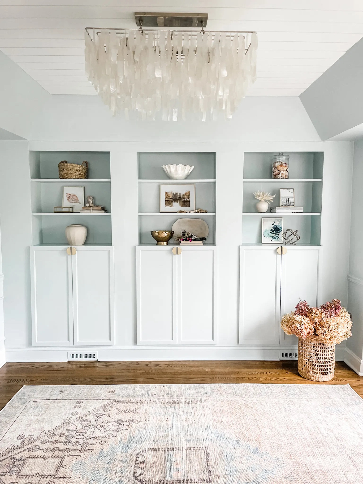 Shelf decor, IKEA Billy bookcase, capiz chandelier, area rug, pastel area rug, coastal chandelier, west elm chandelier, built-in bookshelves, Studio McGee for Target decor, machine washable rug, Target area rug, neutral decor, home office decor. West Elm, Target, Amazon.

Get the full details on this IKEA hack Billy bookcases on heatherkrout.com