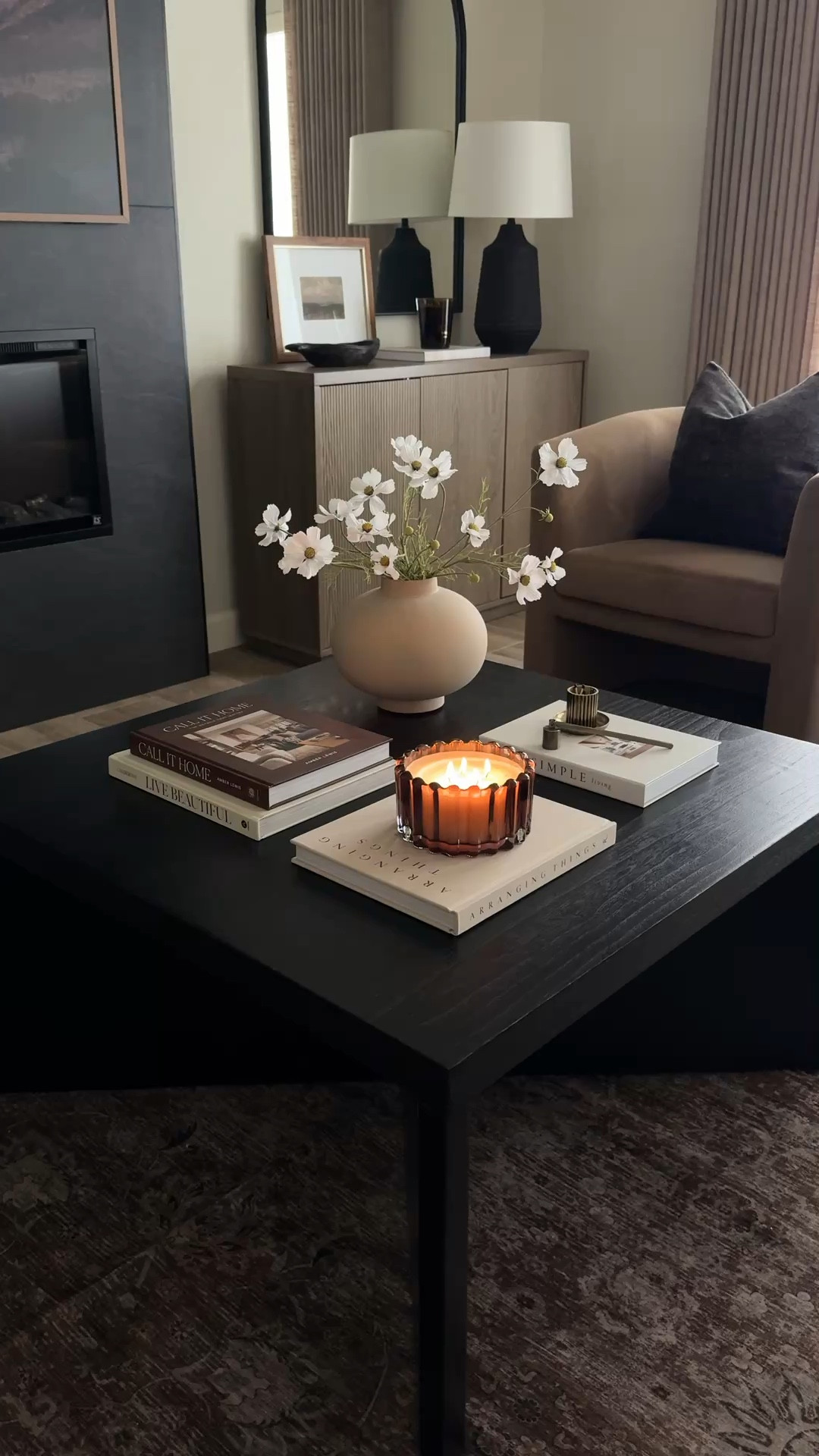 My go-to formula for styling a square coffee table 🤍 

I like to separate the table into quadrants. Using something that adds height like florals, then some books for layering, and lastly something visually interesting, like this ribbed candle. I like adding some smaller accents like this match holder and candle snuffer. 
This is my easy and repeatable method for any square coffee table!! 


#LTKSeasonal #LTKHome #LTKSaleAlert