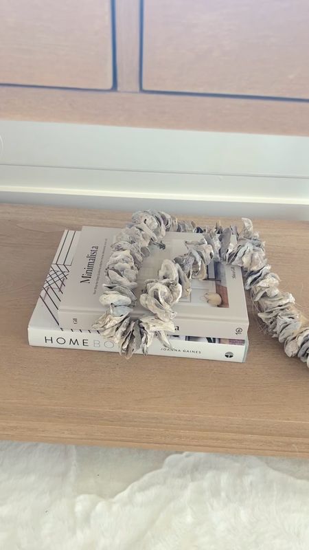 Coffee table books and oyster shell garland to decorate a nightstand  

#LTKstyletip #LTKhome #LTKunder50