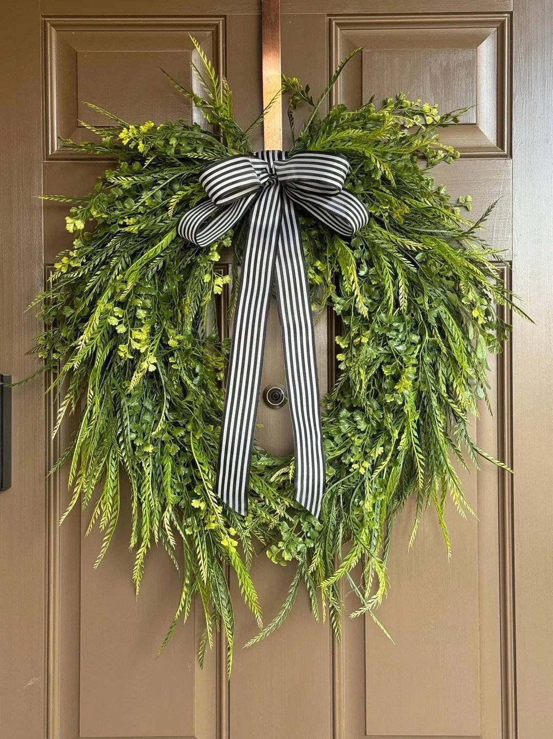 Refresh your front door with this elegant grapevine wreath featuring cascading greenery and soft floral accents for a natural, flowing look. The black-and-white striped ribbon adds a modern farmhouse touch, creating the perfect balance of rustic charm and timeless style. Designed for spring and summer, this handcrafted wreath makes a beautiful statement for your entryway, kitchen, or any space that needs a fresh, welcoming feel.

#LTKHome #FrontDoorDecor #SpringWreath #SummerDecor #FarmhouseDecor #GrapevineWreath #ModernFarmhouse #HomeDecorIdeas #SeasonalDecor #EntrywayDecor #RusticHome #HomeInspiration #LTKFinds #WreathDecor #SpringHome 

#LTKSeasonal #LTKdayinmylife #LTKHome