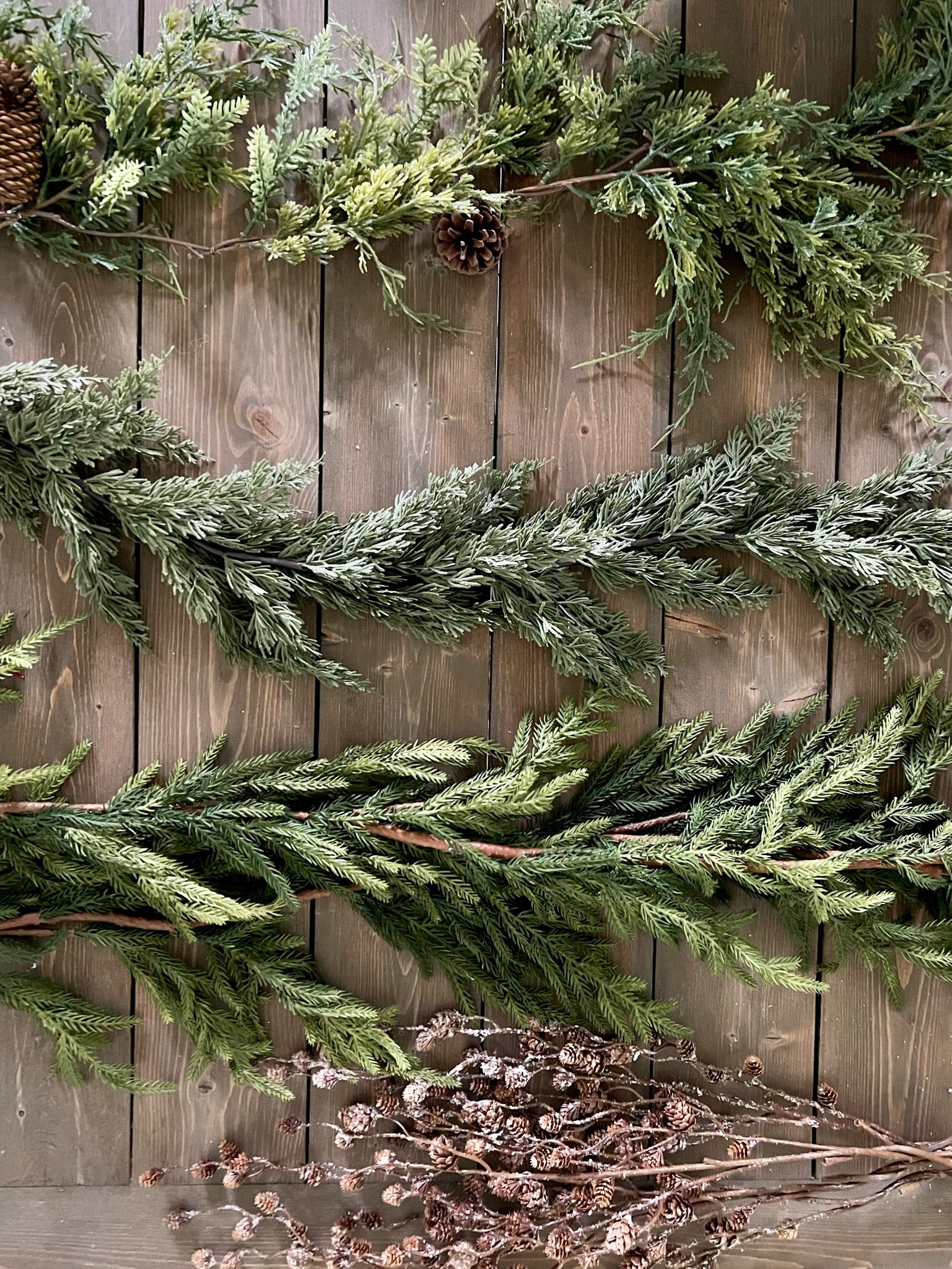 The garland I’m using on my mantle this year! All very natural and realistic looking. 
From the top: 
Cedar pine Mix 
Faux cedar
Real touch Norfolk pine
Mini pinecone stems 
Holiday greenery, faux garland 