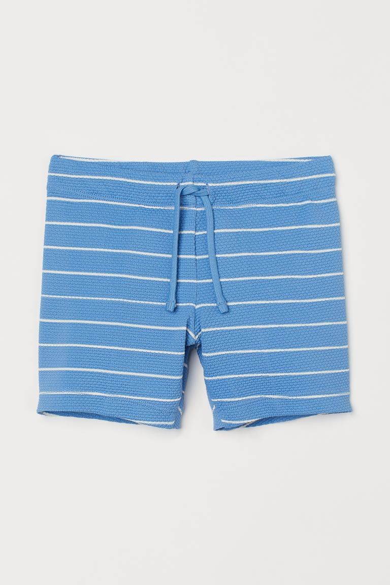 Kids Exclusive. Textured swim trunks. Elasticized waistband with drawstring. Lined front. | H&M (US + CA)