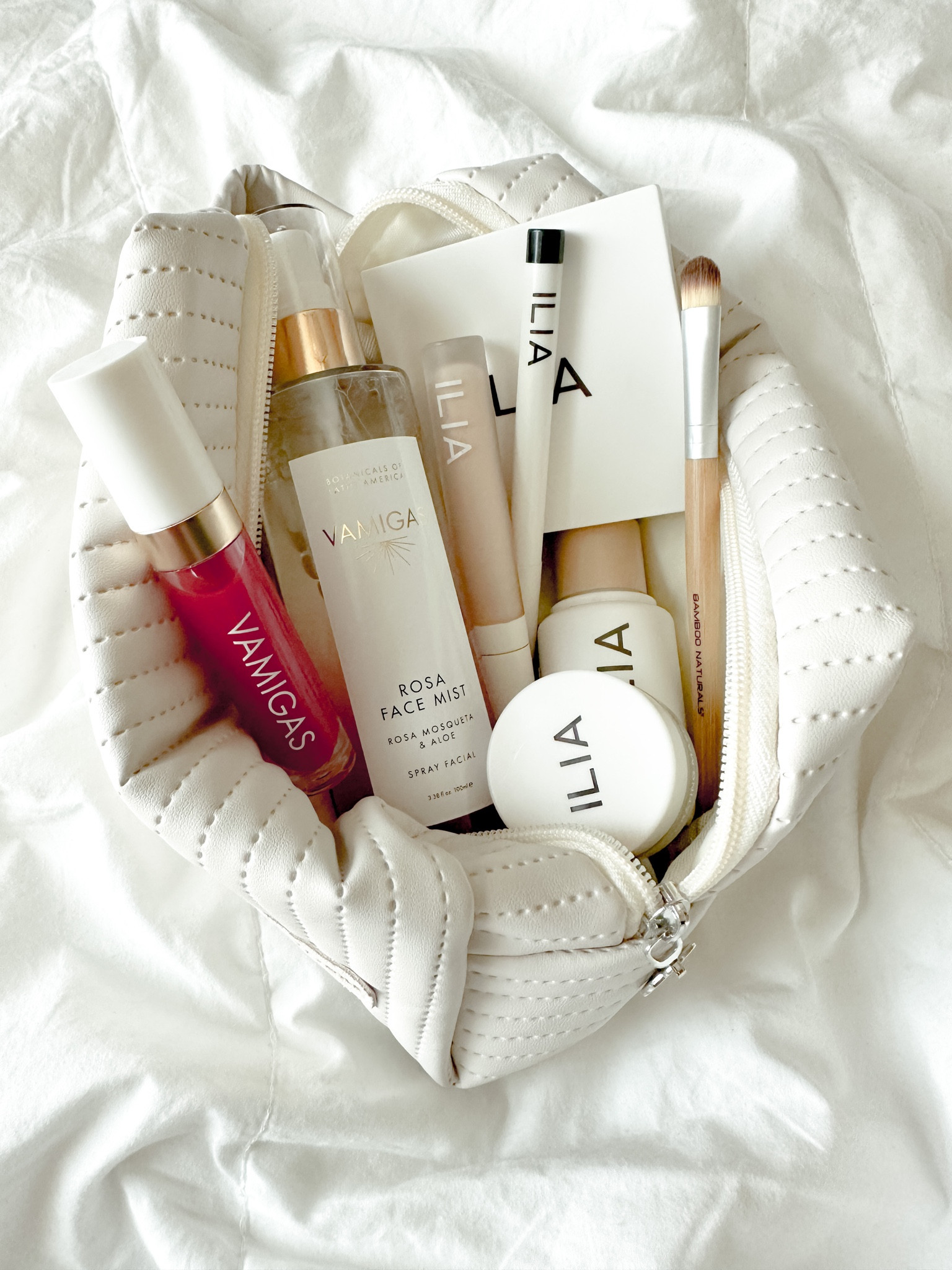 My fave clean beauty essentials, VAMIGAS face mist, ILIA skin tint, lip treatment, lipstick, naked eyeshadow, concealer, lip oil, eyeliner 