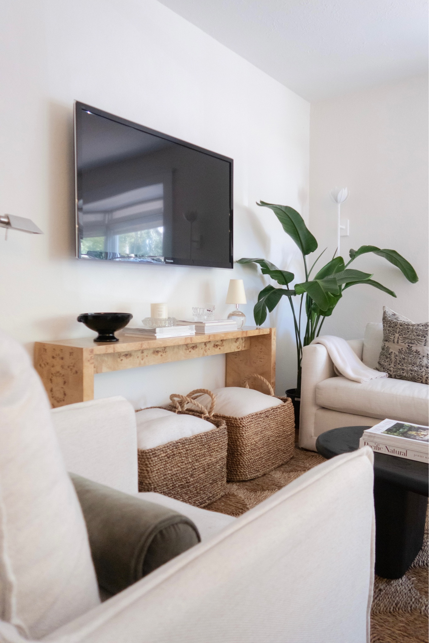 A few living room details including our Burl wood console table and white couch. The swivel chairs were a local marketplace find. 

#LTKunder100 #LTKhome #LTKstyletip