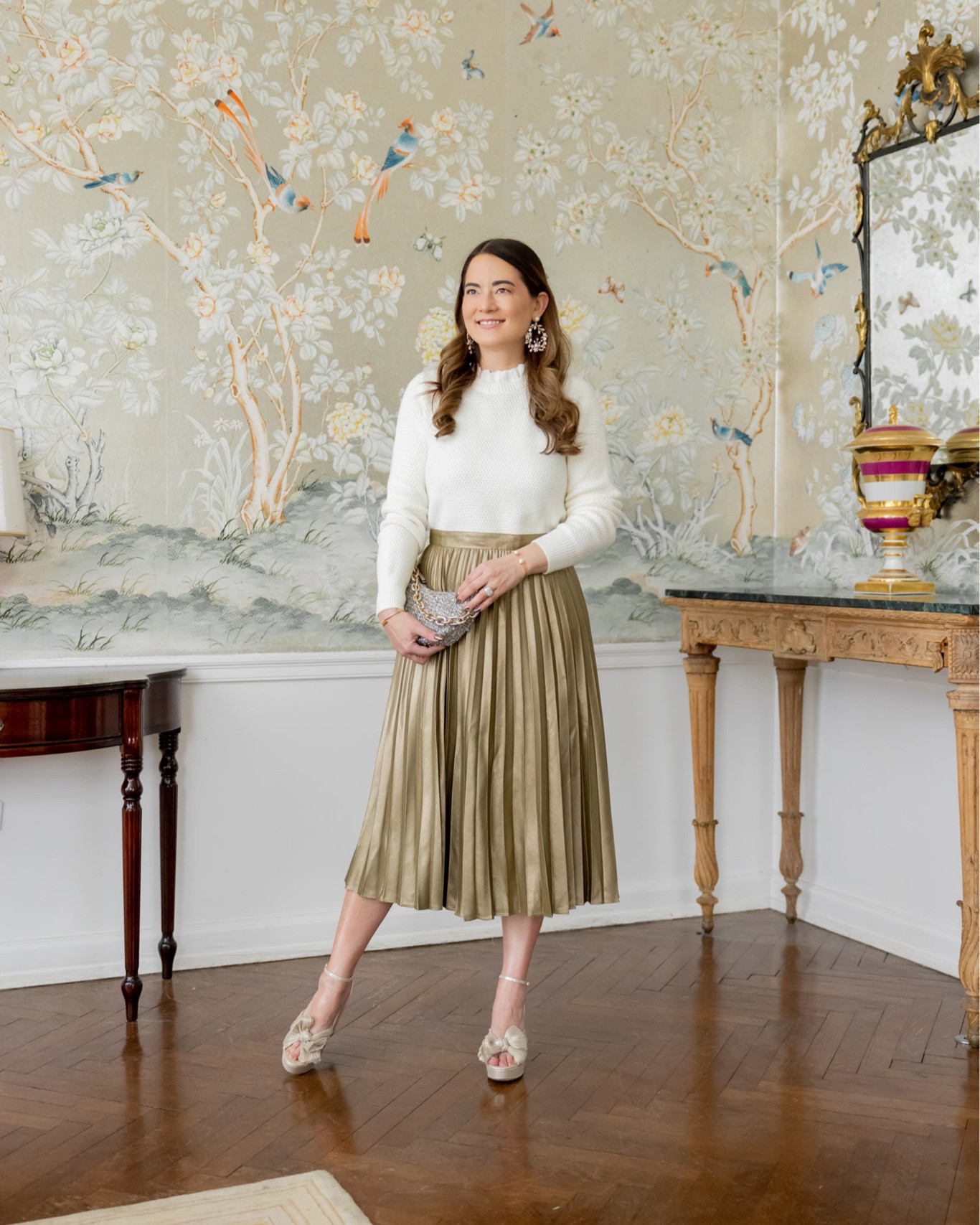 A classic holiday look from Ann Taylor including this gold pleated midi skirt, ivory sweater, and statement jewelry

#LTKunder100 #LTKstyletip #LTKHoliday