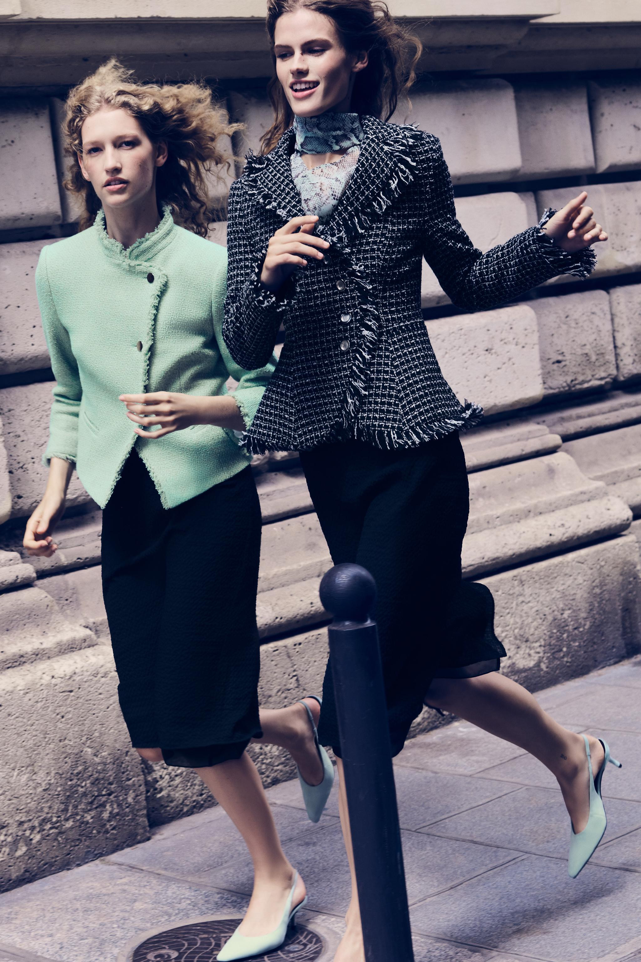Stand collar blazer with long sleeves. Features front welt pockets, frayed trim finishes, and a d... | Zara US